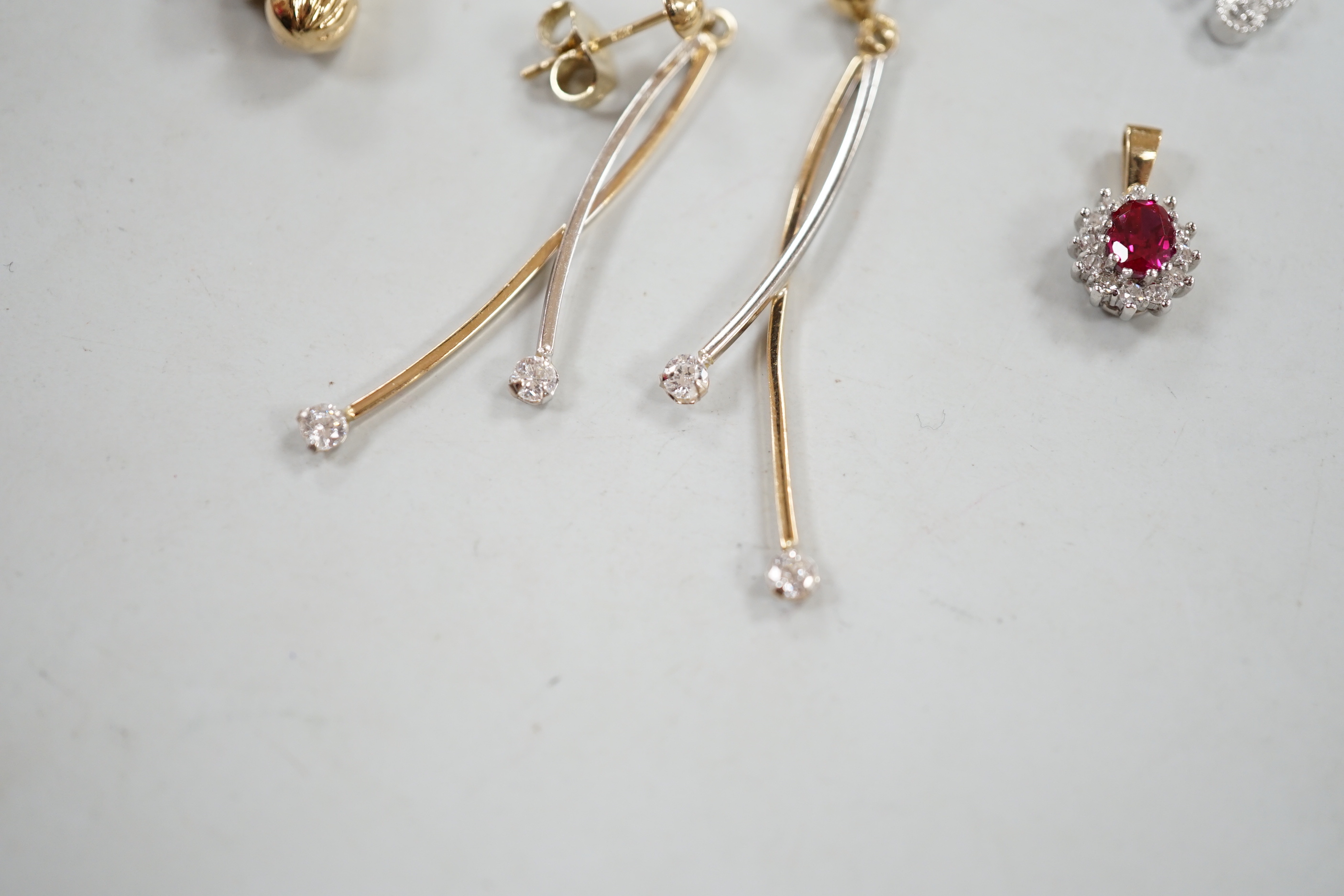 Five assorted modern pairs of 9ct and gem set earrings, including diamond chip cluster drop and blue topaz set demi lune, together with three assorted modern 9ct or yellow metal and gem set small pendants, gross weight 1
